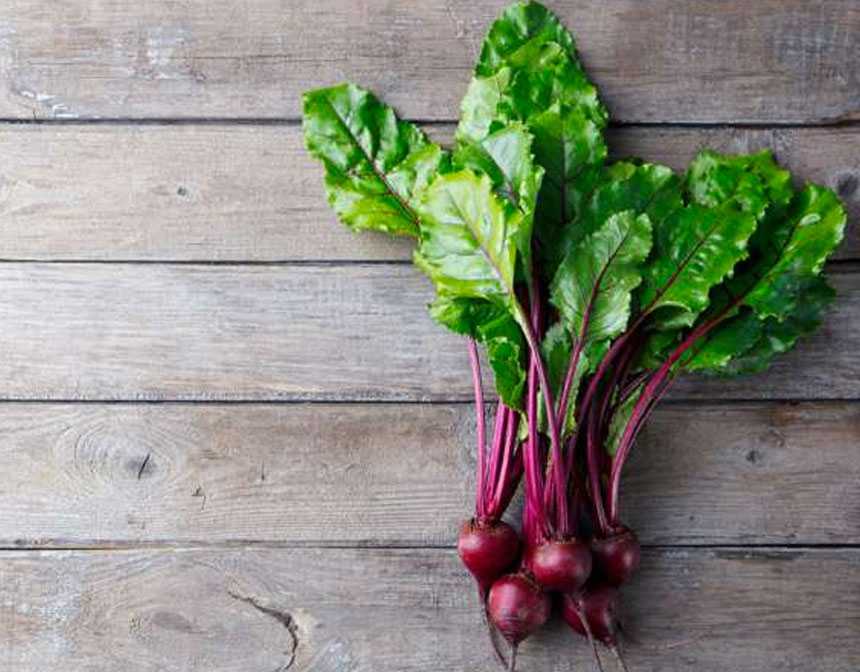 Beet leaves on brown surface