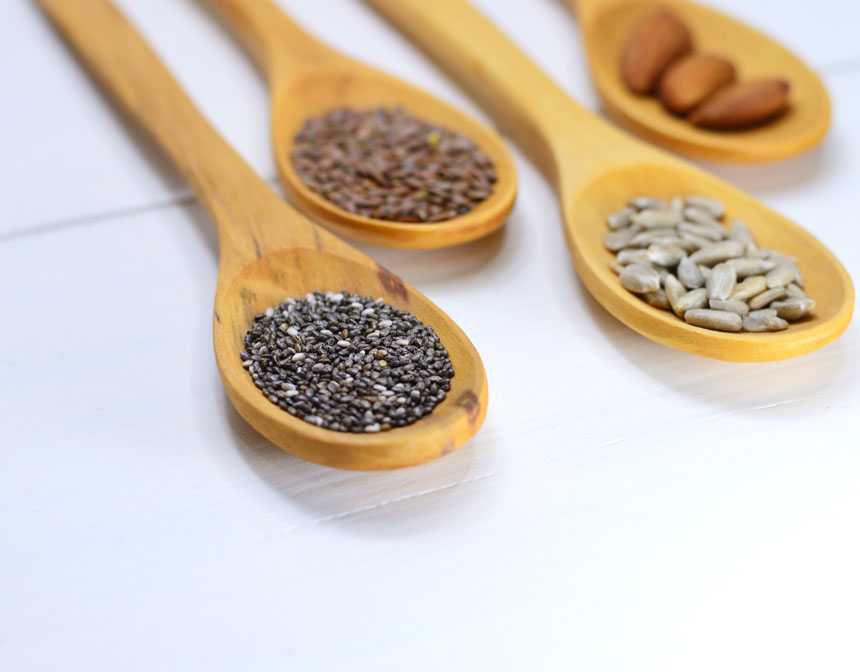 Close-up wooden spoons with seeds