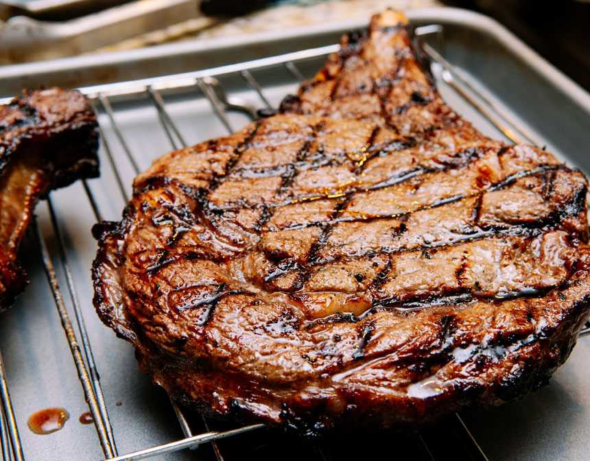 Grilled meat on stainless steel tray