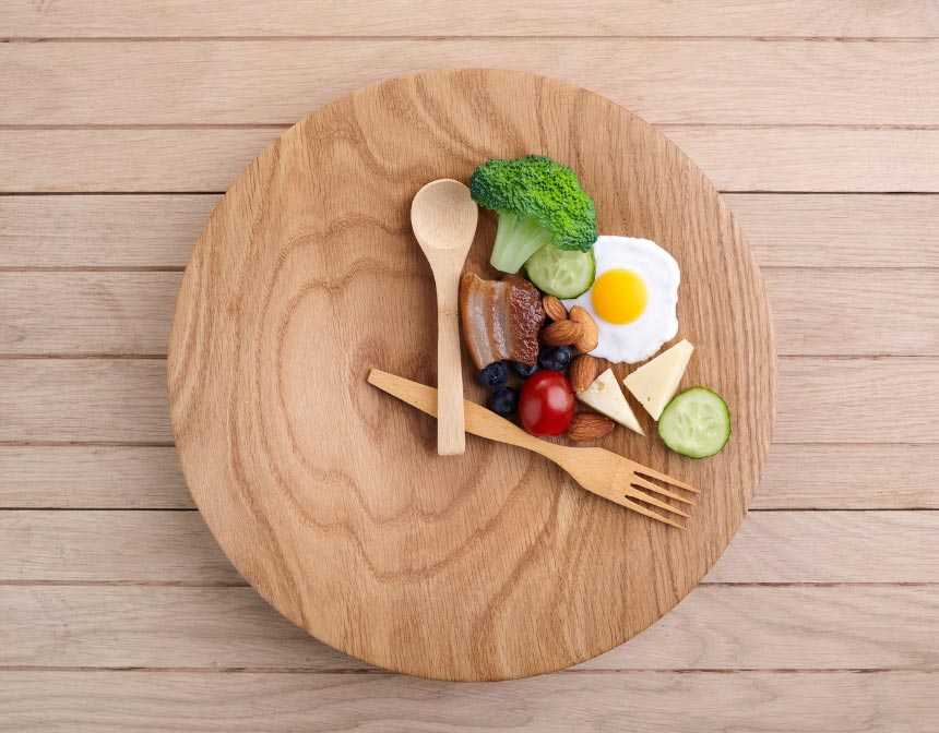 Healthy food on a wooden plate with spoon and fork