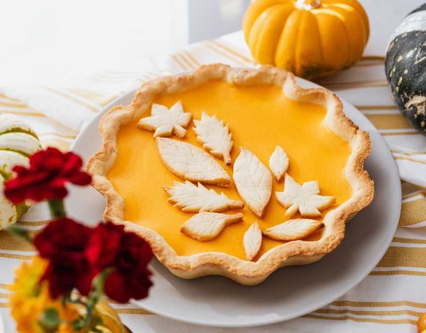 Orange pumpkin pie on white plate