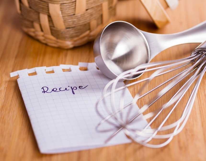 paper with recipe written on it near a whisker and a measuring spoon