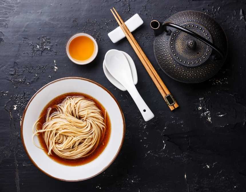 Ramen broth with chopsticks