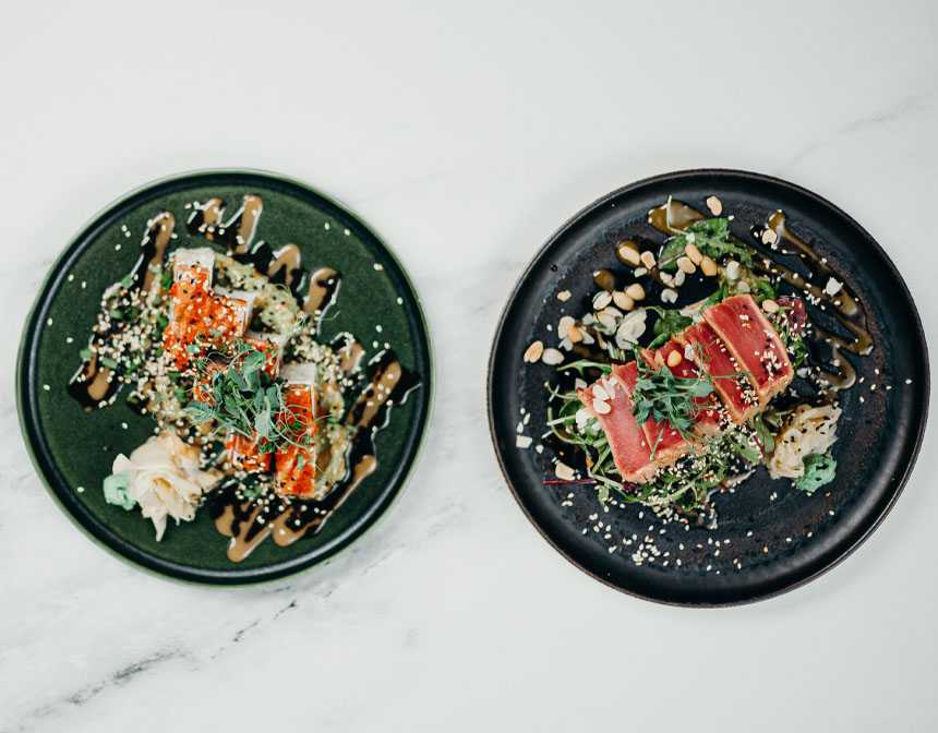 Tuna and sushi on black plates