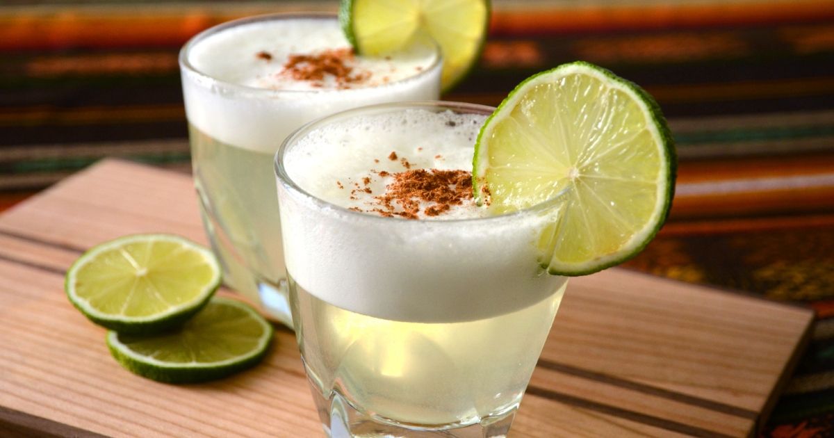 Two pisco sour cocktails with lime